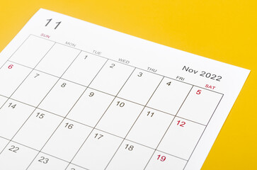 November 2022 calendar sheet on yellow background.