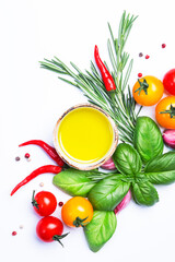Fresh summer spicy herbs and spices for mediterranean diet. Banner. Tomato, green basil, olive oil, garlic and other. Vegan healthy food on white background. Cooking concept, top view