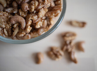 Roasted walnut and cashew, lie in a plate on the table. Protein, useful nuts. Nut Mix