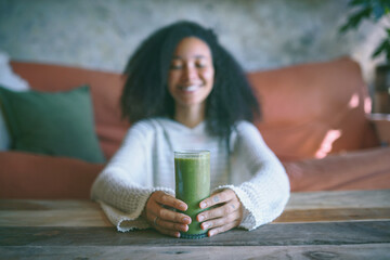 Girl smiling at her green smoothie