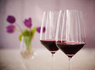 Two Glasses of Burgundy Wine With Purple Flowers in the Background