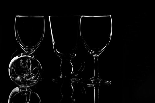 wine glass photographyand  product photography using light effects and low light on a black background
