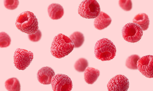 Various falling fresh ripe raspberries on light pink background