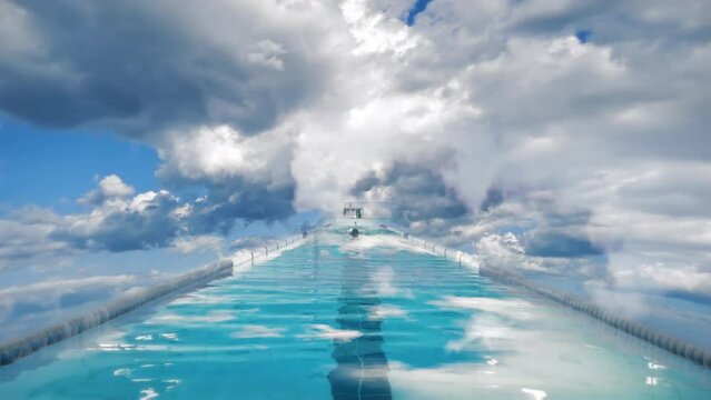 Man Swimming In Clouds In Sky Pool, Sports Abstract Background. Male swimmer in cloudy sky swimming pool. Sports abstract motion background