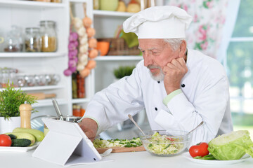 Senior man  preparing dinner in kitchen