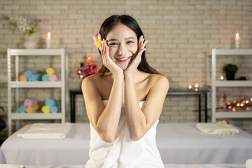 A beautiful and bright Asian teenage girl in Thailand is preparing to have a spa treatment at a spa salon.