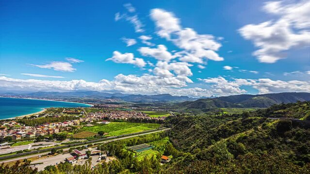 White Clouds In The Blue Sky Over Lush Green Mountains, Seascape And Messina City From Archaeological Park of Tindari. - timelapse