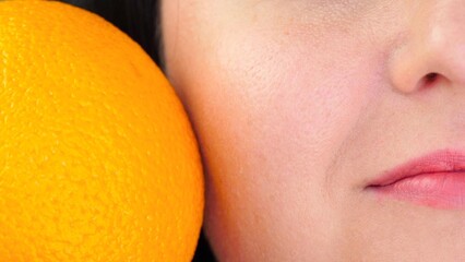 Part of a woman's face in close-up. Skin with enlarged pores and orange peel. Skin problem.