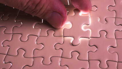 Hand holding jigsaw puzzle last missing piece lighting. 
Concept last piece of jigsaw puzzle for problem and 
completion.