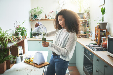 Young african girl preparing her healty smoothie