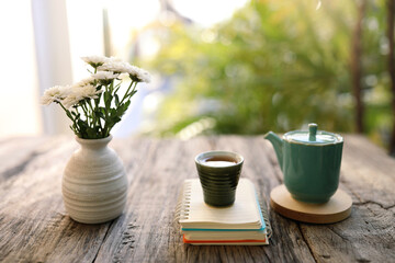 Old vintage ceramic cup and tea pot with white chrysanthemum vase