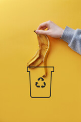 A man throws food waste into a dumpster .Sorting and recycling of garbage