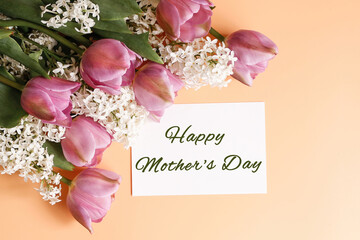 Postcard with text Happy Mother's Day and a bouquet of spring flowers on a yellow background....