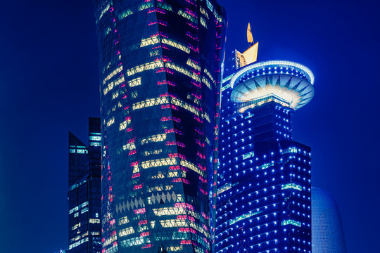 Doha, Qatar - Apr. 2020: Night view in the city center of Doha, Qatar with many modern luxury buildings and skyscrapers illuminated with numerous lights.