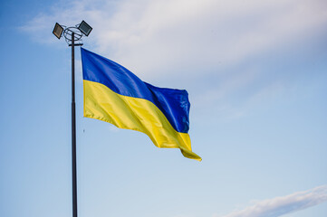 Ukrainian flag on the blue sky background