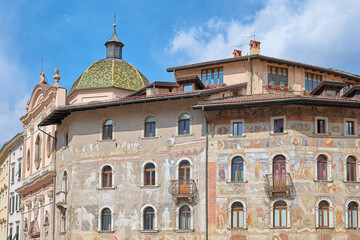 Fototapeta na wymiar Historic building in the Duomo square in Trento, painted facade