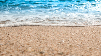 Fototapeta na wymiar Beach sand sea water summer background. Sand beach desert texture. White foam wave sandy seashore