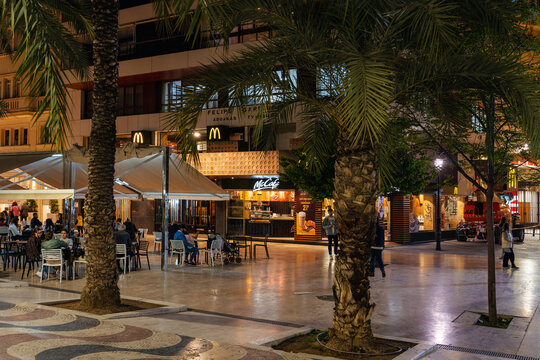 Alicante, Spain - Apr. 2022: View of the tables and facade of a fast food restaurant in the city center
