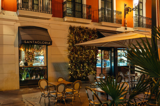 Alicante, Spain - Apr. 2022: View of the entrance to the city cafe in the city center with tables outside