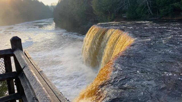 Tahquamenon Falls in the Upper Peninsula of Michigan at sunrise in slow motion.