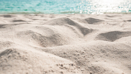 Beach sand sea water summer background. Sand beach desert texture.
White foam wave sandy seashore