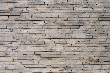   Stone cladding wall . Decorative exterior wall  background from broken sandstone in grey tones