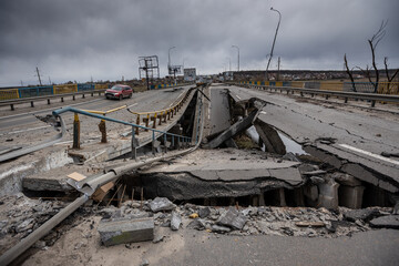 Hostomel, Kyev region Ukraine - 09.04.2022: Cities of Ukraine after the Russian occupation. Bridge over the river Irpin. The bridge was blown up to prevent Russian troops from passing through. - obrazy, fototapety, plakaty