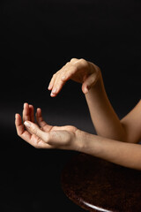 Dancer beautiful hands on a black background