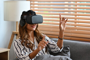 Asian woman wearing a virtual reality technology goggle and holding hand up surprisingly, future technology concept.