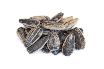 Black dried sunflower seeds isolated on white background.