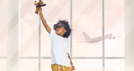 Animation of happy african american boy playing with plane toy over silhouette of plane