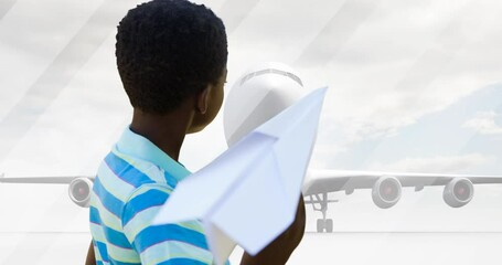 Animation of african american boy playing with paper plane over silhouette of plane