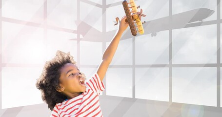 Animation of happy african american boy playing with plane toy over silhouette of plane