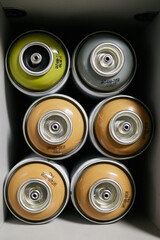 Graffiti paint cans. Graffiti paint cans in a cardboard box. colorful graffiti spray cans
