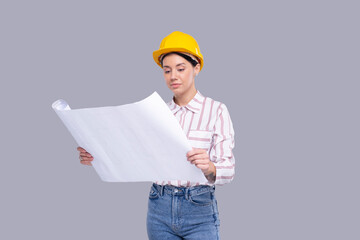 Girl Construction Worker Holding House Plan in Hands Watching at It. Girl Architect Holding Blueprints. Yellow Hard Helmet. Worker