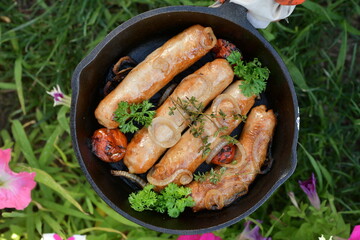 juicy meat sausages fried over an open fire