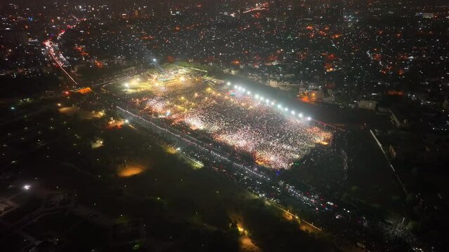 Drone Flying High Over Bagh-e-Jinnah Park Where PTI Party Rally Taking Place In Karachi At Night. Dolly Forward, Tilt Down