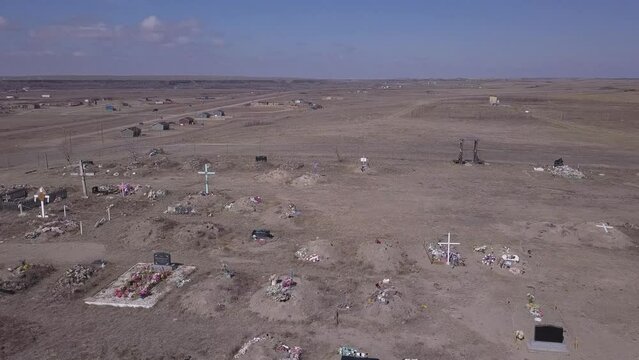 Low flyover of dusty cemetery on Siksika Nation, indigenous reserve