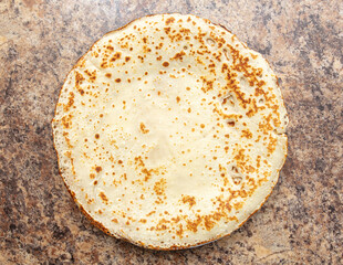 Fried pancakes on a plate on the table.