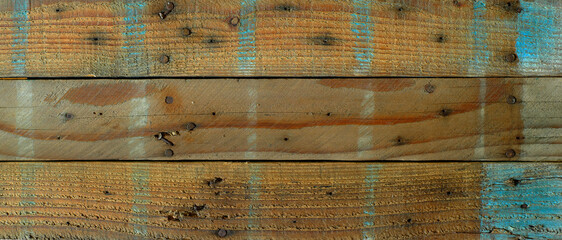 Grungy wooden boards with rough texture and blue paint as background