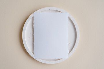 Raw edge handmade paper. Place card mock up on terrazzo plate on beige background. Branding concept 