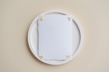 Raw edge handmade paper. Place card mock up on terrazzo plate on beige background. Branding concept 