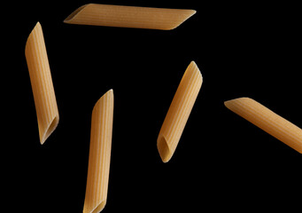 Dried pasta isolated on black background.