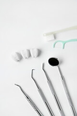 Healthy and whitening tooth with toothbrush, floss and dental instrument on white background brush...