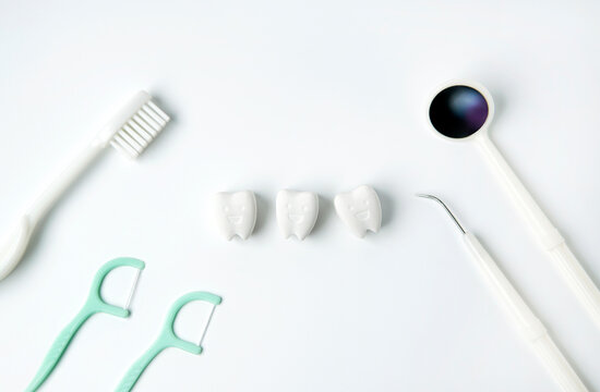 Healthy and whitening tooth with toothbrush, flossing and dental instrument on white background                            