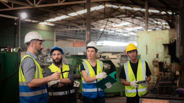 Professional Caucasian Manager Engineer In Safety Uniform Is Training Industry Factory Worker, Workshop Factory Operator, Mechanical Engineering Team Production In Heavy Industrial Manufacture Factory