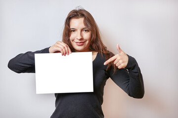 Pretty girl holding a banner, white billboard.