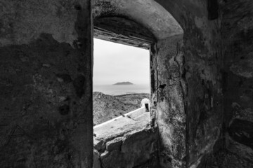 black and white photo of Levanzo island view trough the window of the castle of Santa Caterina, an ancient fort on the island of Favignana. (Egadi) Aegadian Islands, Trapani, Sicily, Italy