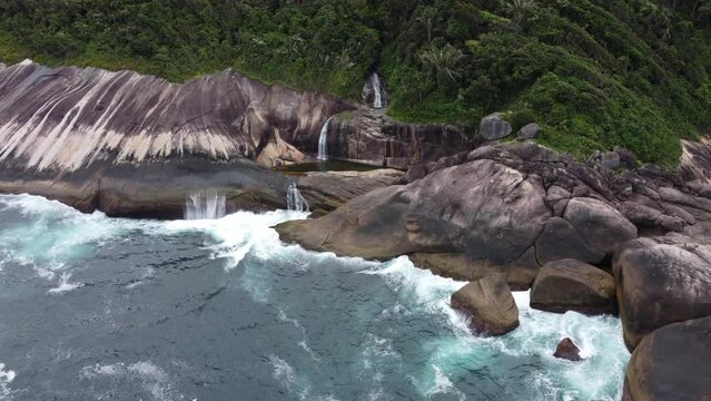 scenic waterfall in front of the sea in Paraty - Rio de Janeiro, Brazil. The amazing Saco Bravo cascade