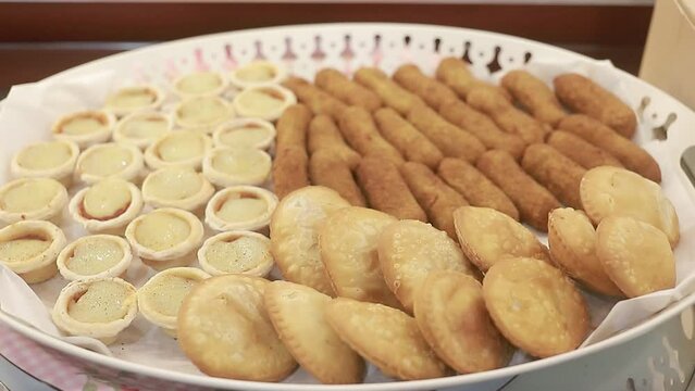 Appetizers on a tray full of pastries and empanada to share, homemade fast food.